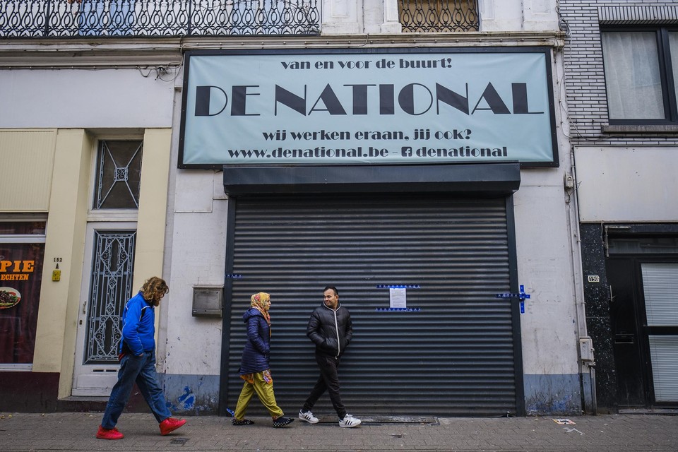 Mensen wandelen voorbij de National, die in het kader van het gerechtelijk onderzoek is verzegeld.
