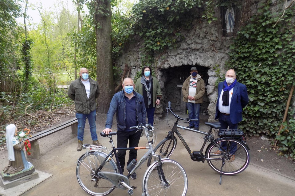Leden van de partij CDE-Vlim.be met vooraan Werner Maes en burgemeester Bart Craane (rechts) fietsen langs de Lourdesgrot in het park Echelpoel in Beerse.