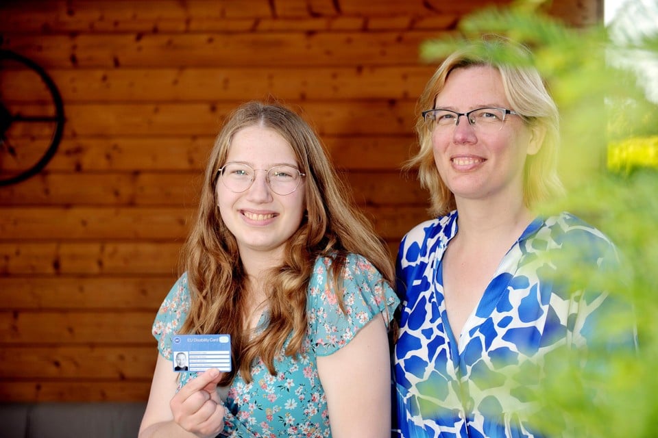 Lindsey en haar mama Debby Rombaut met een European Disability Card. “Iedereen met een gekende beperking zou de kaart automatisch moeten krijgen.” 