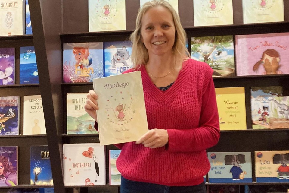 Nancy Vanhees poseert trots met haar eerste boek over Marliepje. 