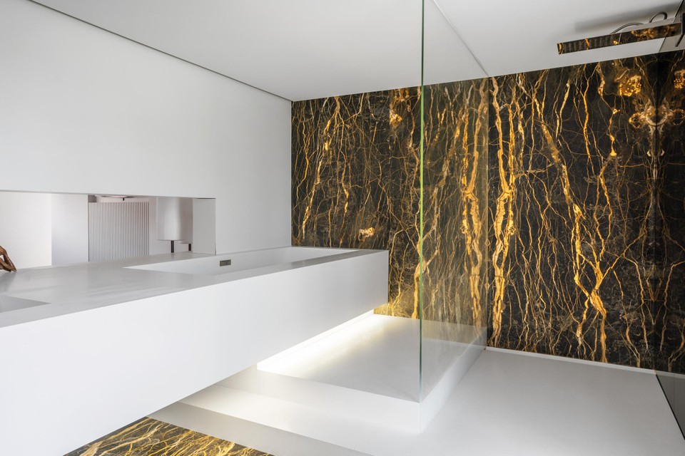 High end finished bathroom with walk in shower and built in tub in sink.