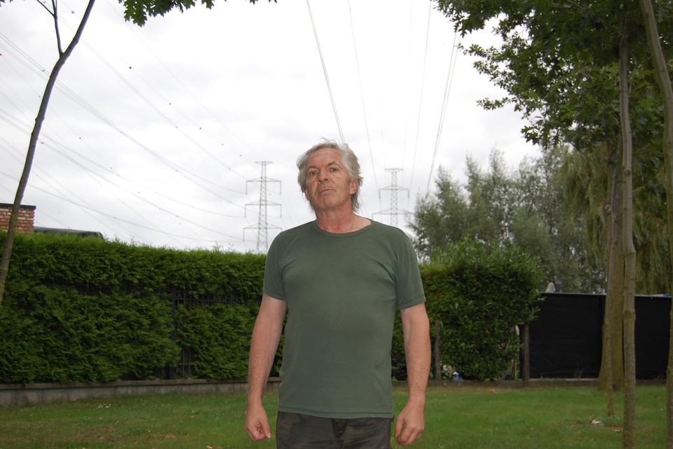Koen in zijn voortuin, die overschaduwd wordt door de luchtlijn tussen Bazel en de haven.