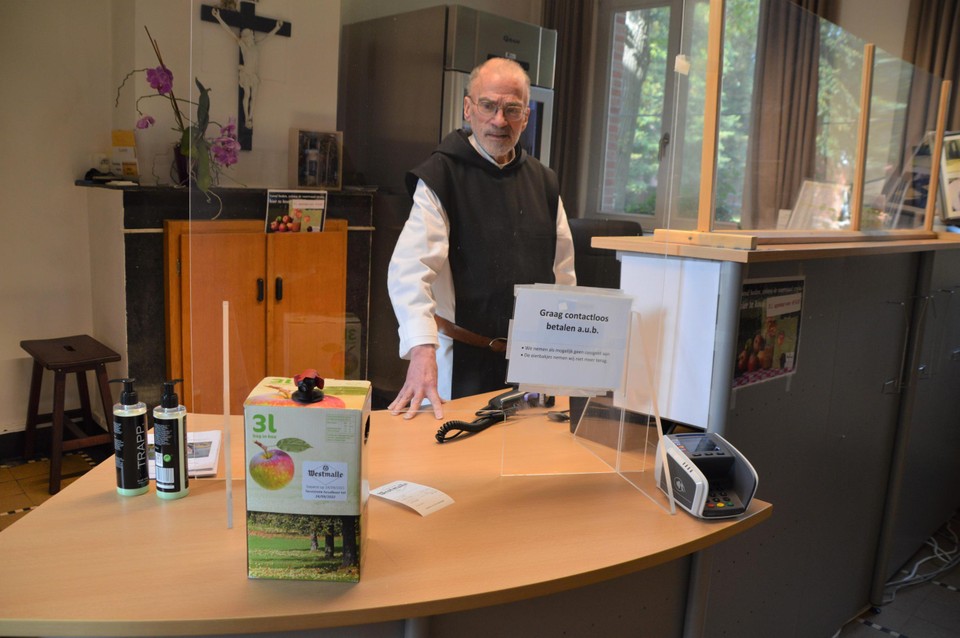 Broeder Francis in de abdijwinkel met een tapkrat appelsap van de Abdij van Westmalle.