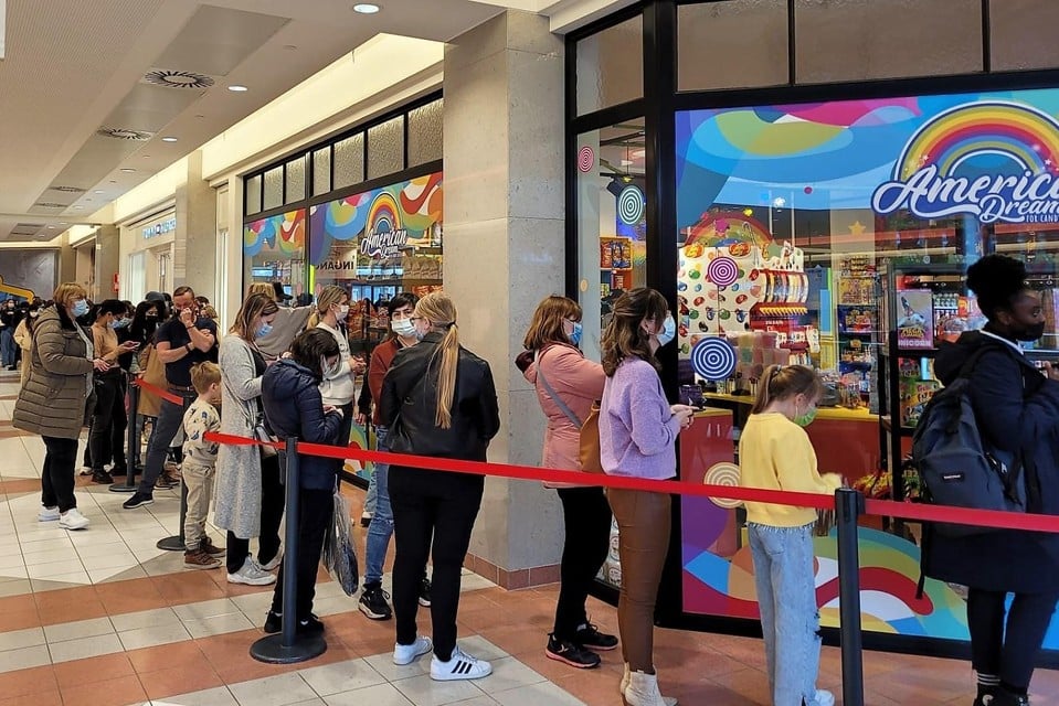 Fans waited until the new candy store opened. 