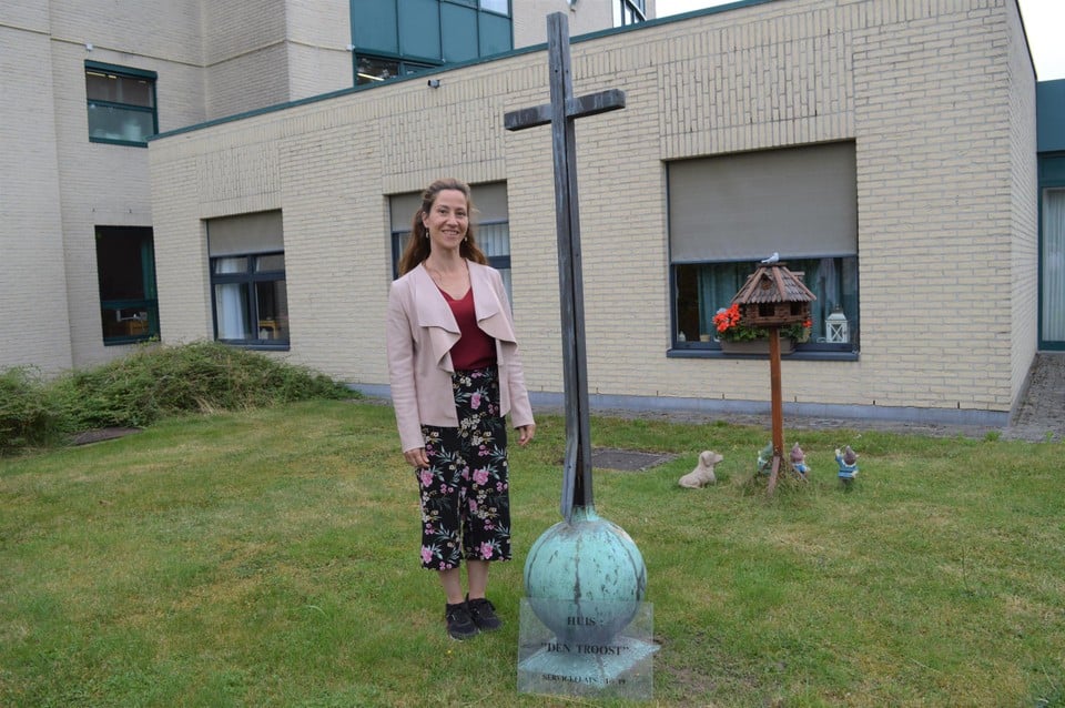 Charlotte Leemans naast het kruis dat op het klooster stond. 
