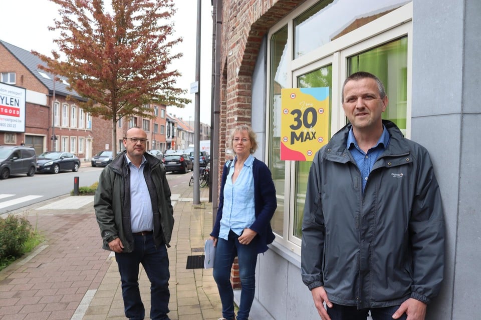 Schepen voor Mobiliteit Carl Hanssens (links), buurtbewoonster Ria De Malsche en mobiliteitsambtenaar Jurgen Goeminne: wie dat wil, krijgt net als Ria een bord om aan het raam te hangen. 