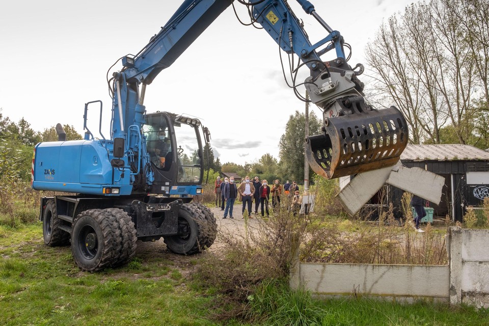 Een kraan sloopt het eerste beton op het voetbalterrein op de Stuivenbergbaan. 