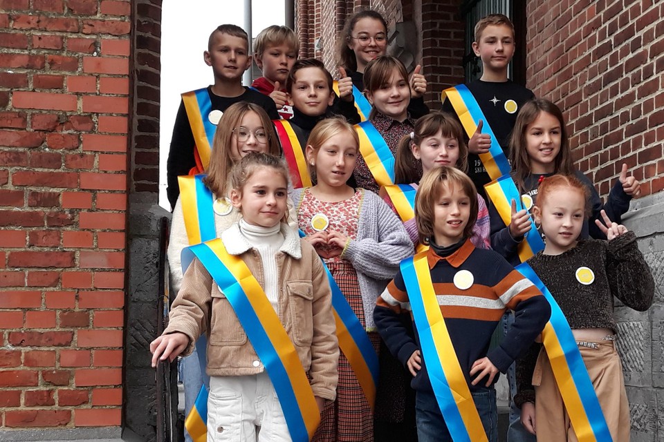 ‘Kinderburgemeester’ Arne Raes (met het Belgische lint om zich) en zijn collega’s raadsleden van de kindergemeenteraad nemen hun opdracht ernstig.